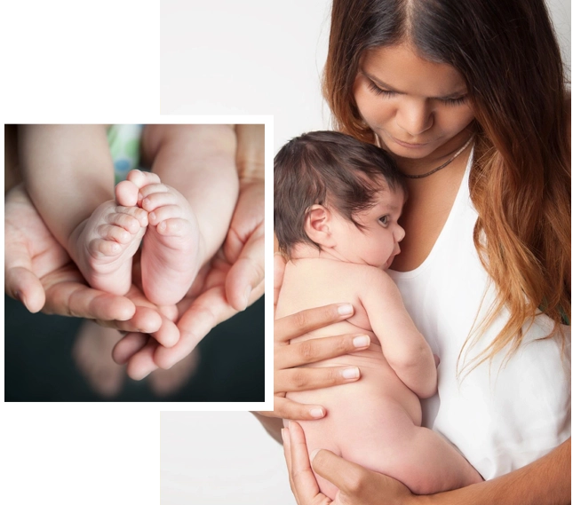 A woman holding a baby in her arms.