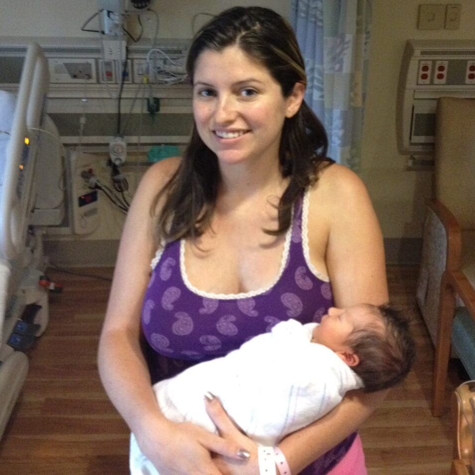 A woman holding a baby in her arms.