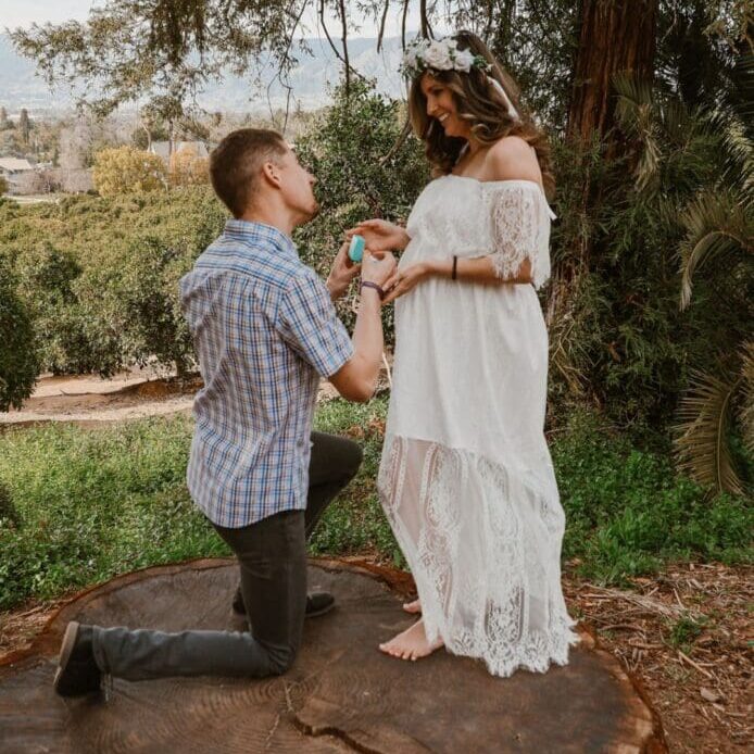 A man kneeling down to propose to his girlfriend.