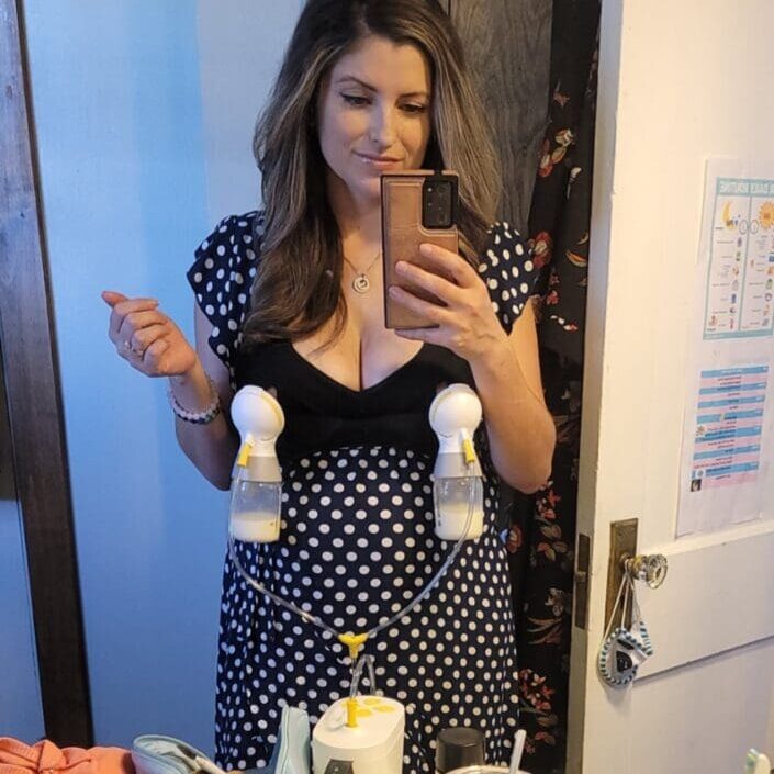 A woman taking a selfie in front of the mirror.